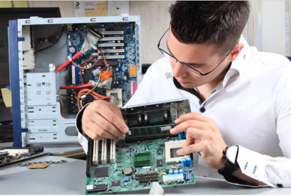 Technician repairing computer hardware at Mega Mobile Harrow